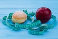 Donut, apple and measuring tape. Royalty Free Stock Photo