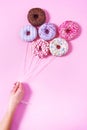 Donut ballons holding by a woman`s hand.