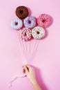 Donut ballons holding by a woman`s hand.