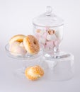 Donut, bun, cookie & glass jar on background Royalty Free Stock Photo