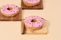 Donut covered with pink glaze and sprinkled with colorful sprinkles