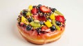 A donut is decorated with a variety of colorful and fruity toppings