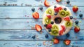 A donut is decorated with a variety of colorful and fruity toppings