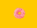 Donut glazed with pink strawberry icing sugar sprinkles floating in air on yellow background. Creative food poster Royalty Free Stock Photo