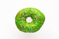 Donut green with sprinkles isolated on white background, close-up