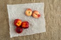 Donut Peaches also known as Saturn peaches and nectarine on a rustic canvas background. Healthy food concept. Royalty Free Stock Photo