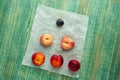 Donut Peaches also known as Saturn peaches, plum and nectarine on a rustic background. Healthy food concept. Royalty Free Stock Photo