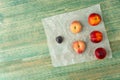 Donut Peaches also known as Saturn peaches, plum and nectarine on a rustic background. Healthy food concept. Royalty Free Stock Photo