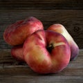 Saturn peaches on wooden table. Royalty Free Stock Photo