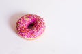 Donut pink on a white background with a sprinkler.