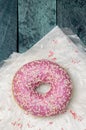 Donut with sugar sprinkles on a turquoise wooden background Royalty Free Stock Photo