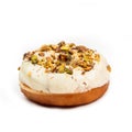Donut with white cream and hazelnut core, isolated on white background. View from side Royalty Free Stock Photo