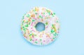 Donut in white glaze and colorful sprinkles top view Royalty Free Stock Photo
