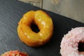 Donut in yellow glaze on grey background. National sweets. High-carbohydrate meals