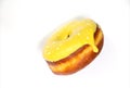 Donut in yellow glaze on an isolated background