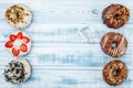 Donuts arranged by parts, on old wood background. Top view. Space for text