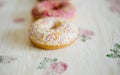 Three donuts on a background in the style of a shabby chic. Royalty Free Stock Photo