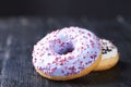 Donuts with blue and vanilla icing on a dark background