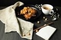 donuts with caramel and hazelnuts, cup of coffee on the rustic table Royalty Free Stock Photo