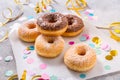 Donuts for carnival and party. Donuts with streamers and confetti Royalty Free Stock Photo