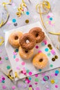 Donuts for carnival and party. Donuts with streamers and confetti Royalty Free Stock Photo