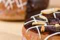 Donuts chocolate glazing on wooden background, Assorted Colorful.