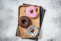 Donuts with chocolate, pink glazed and sprinkles Doughnut. White background. Top view