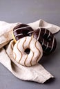 Donuts with Chocolate and Vanillas Icing on Linen Napkin on Gray Background Tasty Dinuts Morning Breakfast Coffee Royalty Free Stock Photo