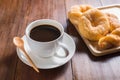 Donuts and Coffee cup on wooden background Royalty Free Stock Photo