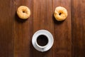 Donuts and Coffee cup on wooden background, top view Royalty Free Stock Photo