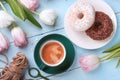 Donuts, coffee and tulips on a blue wooden background. Royalty Free Stock Photo