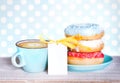 Donuts & cup coffee on wooden table background. Royalty Free Stock Photo