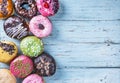 Donuts with different fillings on a blue wooden table Royalty Free Stock Photo
