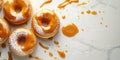 Donuts dipped in caramel glaze on a light background with copy space