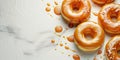 Donuts dipped in caramel glaze on a light background with copy space