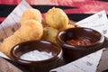Donuts, fried on hot fan, with the most tasty white and red sauce. Hot and very high-calorie dessert