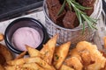 Donuts, fried on hot fan, with the most tasty white and red sauce. Hot and very high-calorie dessert