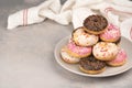 two donuts in a heartshape on a gray background on a white plate. Concept for Valentine's Day. Valentine's Day Royalty Free Stock Photo