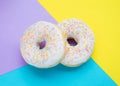 Donuts with icing on pastel colorful background