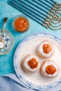 Donuts with jam on a plate and Hanukkah on a turquoise table Royalty Free Stock Photo
