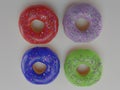 4 donuts with multi-colored icing on a white background. Realistic photo food style 3D render