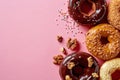 Donuts on pink background, from above