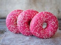 Donuts with pink frosting on the table Royalty Free Stock Photo