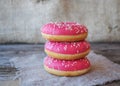 Donuts with pink frosting on the table Royalty Free Stock Photo