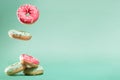 Donuts with pink and green icing with sprinkles