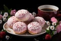 Donuts with pink icing and strawberries on a black plate, flowers on the background Royalty Free Stock Photo