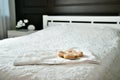 Donuts in the plate on a bed in a bedroom. horizontal