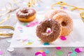 Donuts with streamers and confetti. Donuts for carnival and party. Royalty Free Stock Photo