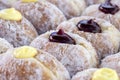 Donuts at street food market in Thailand, closeup. Tasty doughnuts with jam, chocolate and condensed milk Royalty Free Stock Photo