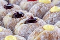 Donuts at street food market in Thailand, closeup. Tasty doughnuts with jam, chocolate and condensed milk Royalty Free Stock Photo